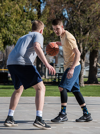Jacob and Jacob, two BYU-Idaho students, play one on one basketball at the Smith Park court.