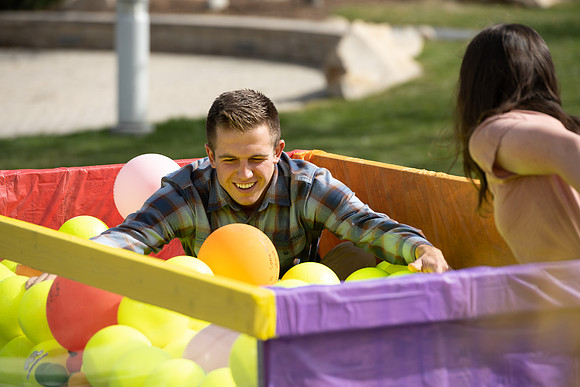 Students who volunteer to participate sit in the ball pit and ask each other questions which are found on the balloons. Video is being produced for Student Living.