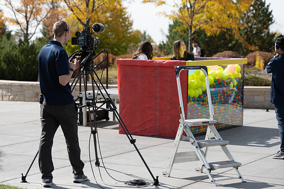 Students who volunteer to participate sit in the ball pit and ask each other questions which are found on the balloons. Video is being produced for Student Living.