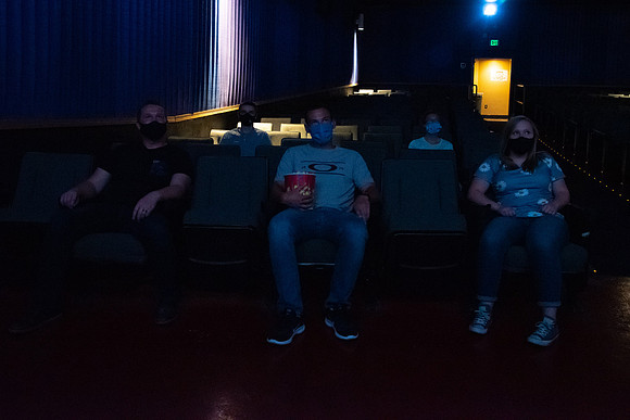 Students at a local movie theater wearing face masks.