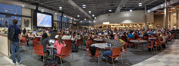 Students gather at the Crossroads in the Manwaring Center to enjoy a Thursday night football game, BYU vs Boise State, on the big screen.