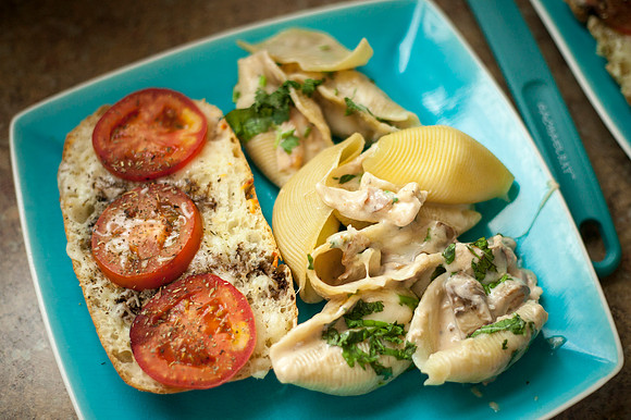 Creamy alfredeo chicken stuffed into a pasta shell and topped with fresh cilantro and sauteed mushrooms.