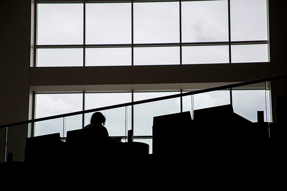 A student finds solitude in the BYU-Idaho Center the week before finals.