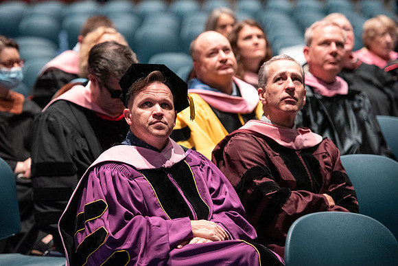 Graduates receive their diplomas during Performing and Visual Arts convocation.