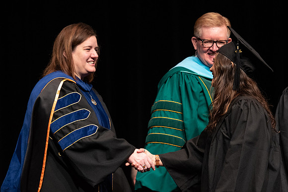 Graduates receive their diplomas during Performing and Visual Arts convocation.