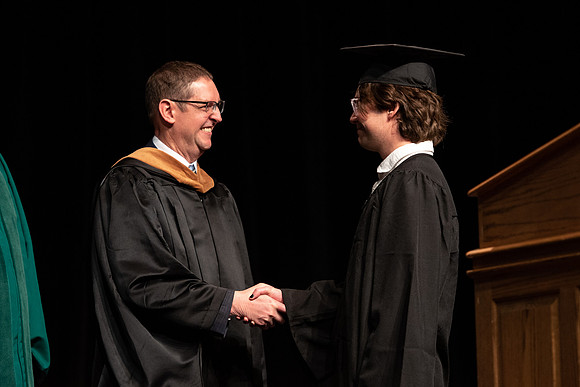 Graduates receive their diplomas during Performing and Visual Arts convocation.