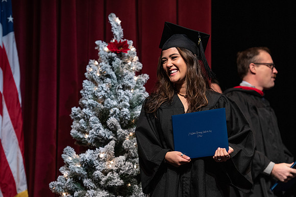 Graduates receive their diplomas during Performing and Visual Arts convocation.