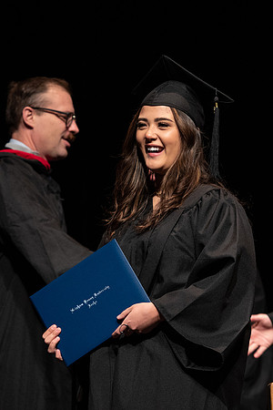 Graduates receive their diplomas during Performing and Visual Arts convocation.