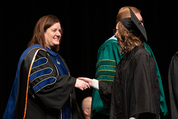 Graduates receive their diplomas during Performing and Visual Arts convocation.