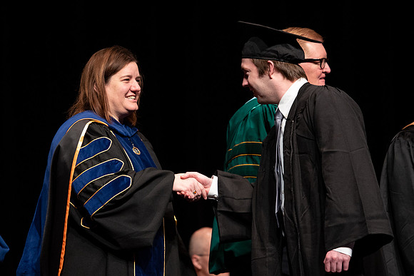 Graduates receive their diplomas during Performing and Visual Arts convocation.