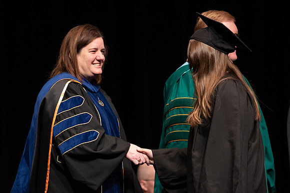 Graduates receive their diplomas during Performing and Visual Arts convocation.