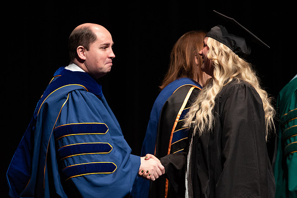 Graduates receive their diplomas during Performing and Visual Arts convocation.