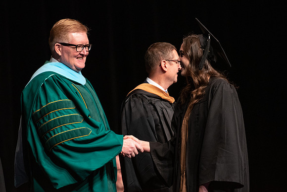 Graduates receive their diplomas during Performing and Visual Arts convocation.