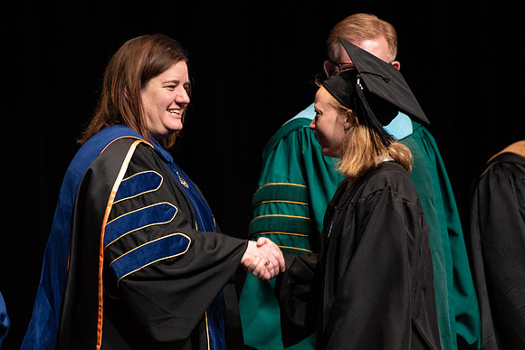 Graduates receive their diplomas during Performing and Visual Arts convocation.