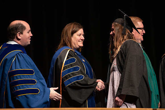 Graduates receive their diplomas during Performing and Visual Arts convocation.