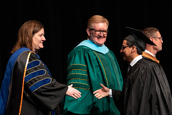 Graduates receive their diplomas during Performing and Visual Arts convocation.
