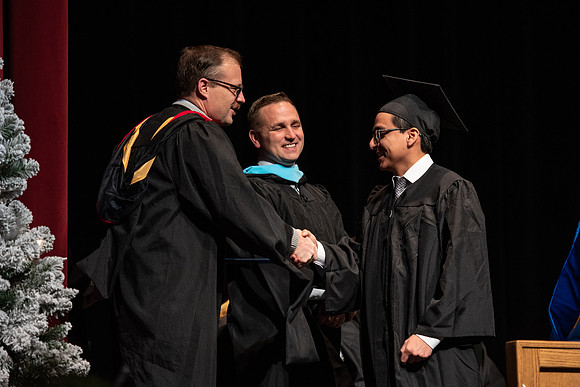 Graduates receive their diplomas during Performing and Visual Arts convocation.