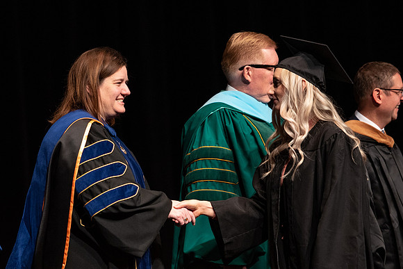 Graduates receive their diplomas during Performing and Visual Arts convocation.