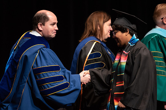 Graduates receive their diplomas during Performing and Visual Arts convocation.