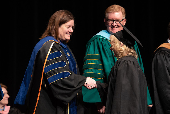 Graduates receive their diplomas during Performing and Visual Arts convocation.