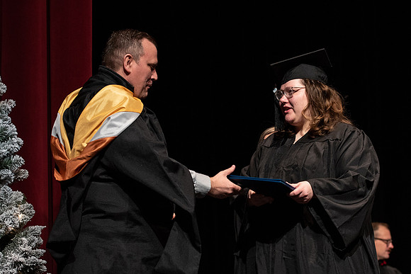 Graduates receive their diplomas during Performing and Visual Arts convocation.