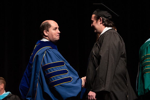 Graduates receive their diplomas during Performing and Visual Arts convocation.