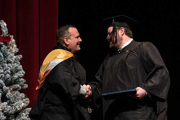 Graduates receive their diplomas during Performing and Visual Arts convocation.