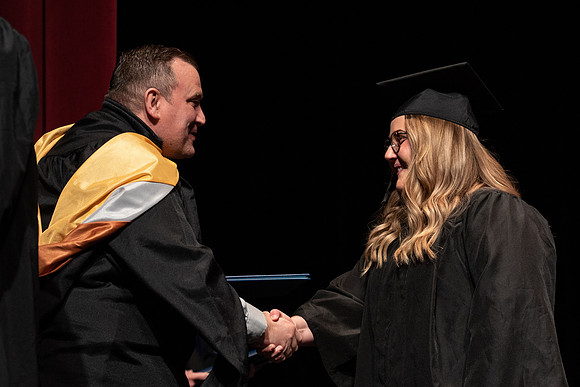 Graduates receive their diplomas during Performing and Visual Arts convocation.