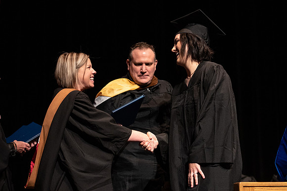 Graduates receive their diplomas during Performing and Visual Arts convocation.