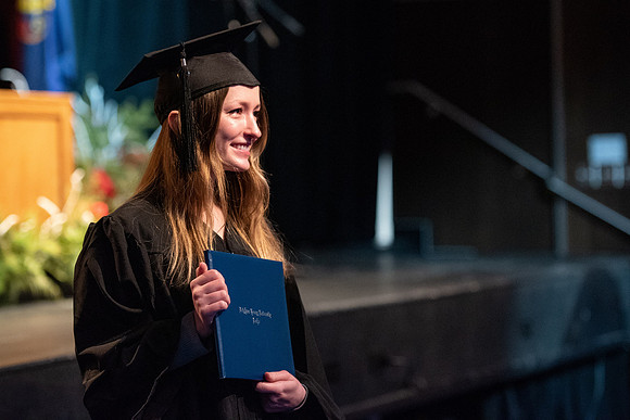Graduates receive their diplomas during Performing and Visual Arts convocation.