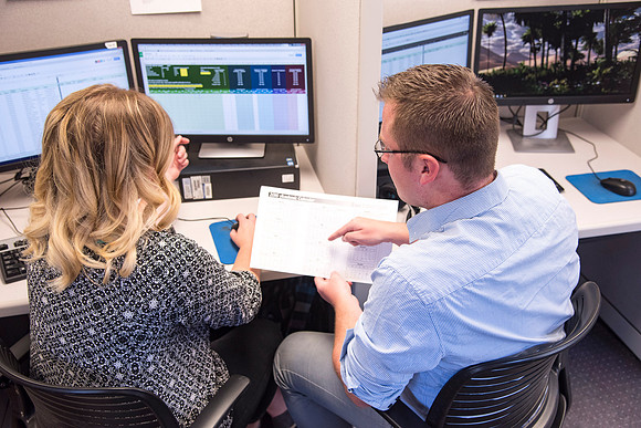 Employees work on developing a better curriculum for online students.