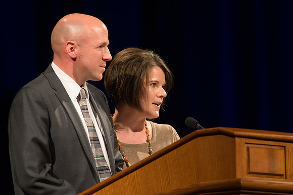 Darik and Kristine Anderson, Alumni Representatives, speaks to graduates.