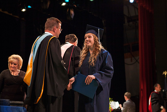 Jon Linford shakes hands with graduates as they are handed their diplomas during Convocation held in the Kirkham Building. Photo by Tyler Rickenbach