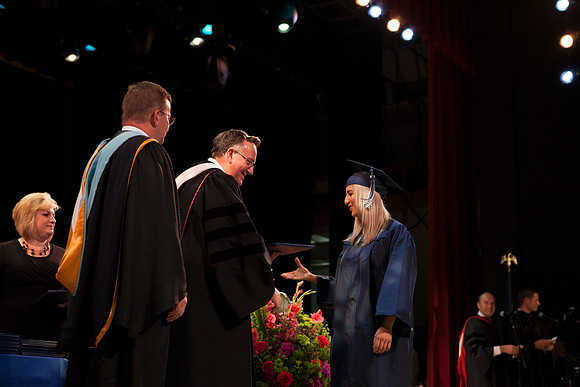 Jon Linford shakes hands with graduates as they are handed their diplomas during Convocation held in the Kirkham Building. Photo by Tyler Rickenbach