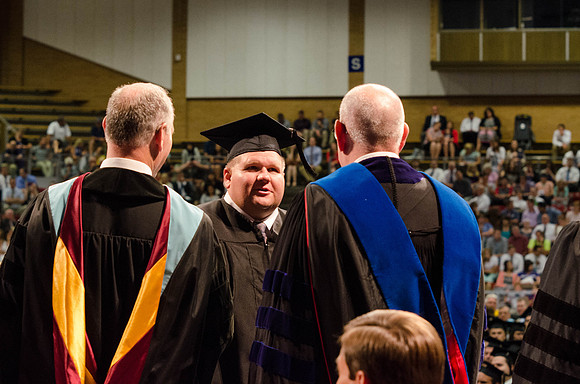 Students recieve their Diplomas during the College of Business and Communication Convocation.