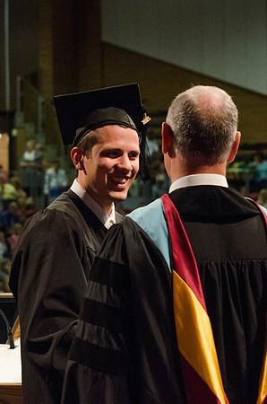 Students recieve their Diplomas during the College of Business and Communication Convocation.