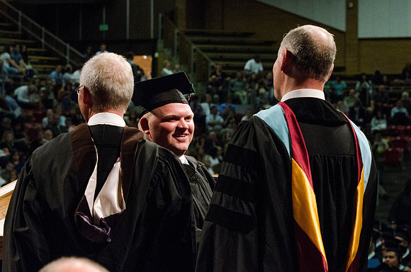 Students recieve their Diplomas during the College of Business and Communication Convocation.