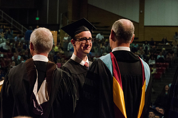 Students recieve their Diplomas during the College of Business and Communication Convocation.