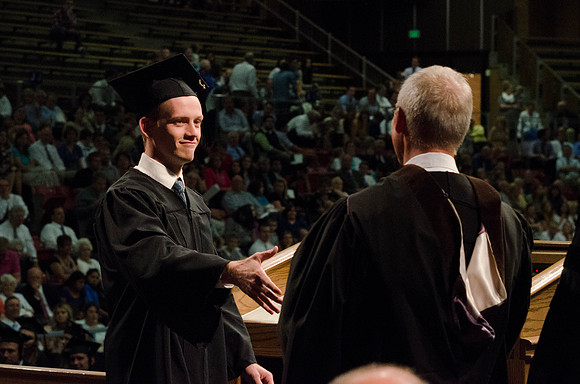 Students recieve their Diplomas during the College of Business and Communication Convocation.