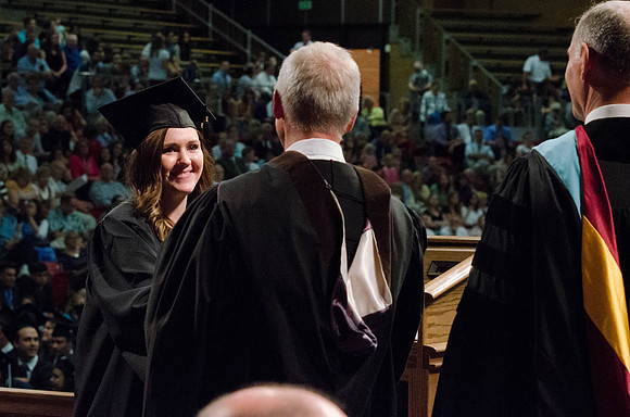 Students recieve their Diplomas during the College of Business and Communication Convocation.