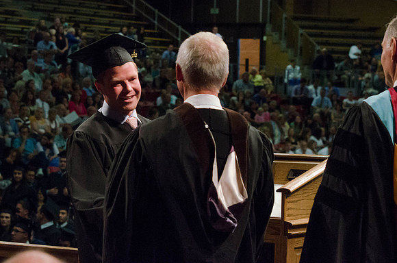 Students recieve their Diplomas during the College of Business and Communication Convocation.