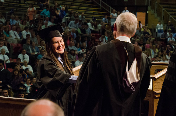 Students recieve their Diplomas during the College of Business and Communication Convocation.