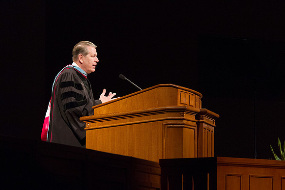 Elder Donald L. Hallstrom, a member of the Presidency of the Seventy, addresses graduates during Commencement in the BYUI I-Center. Photo by Tyler Rickenbach