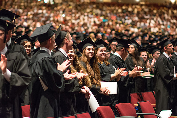 Brigham Young University-Idaho graduates give thanks to parents and teachers at Commencement ceremony. Photo by Ryan Chase