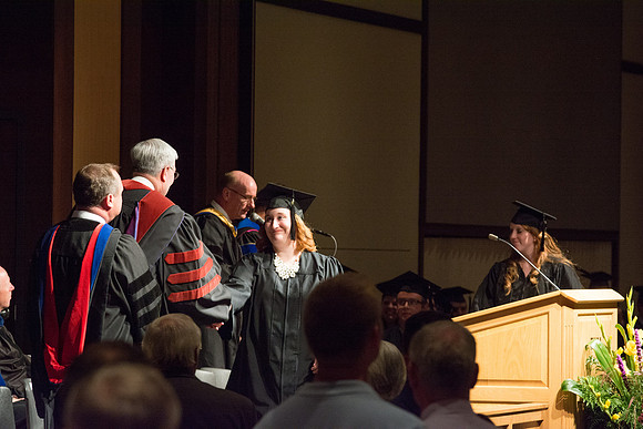 Graduates of the College of Language and Letters receiving their diplomas.