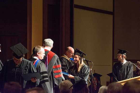 Graduates of the College of Language and Letters receiving their diplomas.