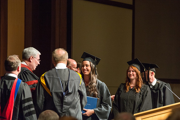 Graduates of the College of Language and Letters receiving their diplomas.