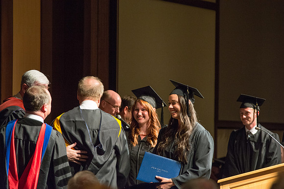 Graduates of the College of Language and Letters receiving their diplomas.