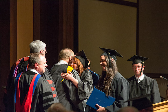 Graduates of the College of Language and Letters receiving their diplomas.