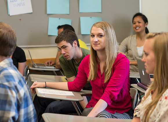Sister Brooke McKenna teaches students in a communication class.